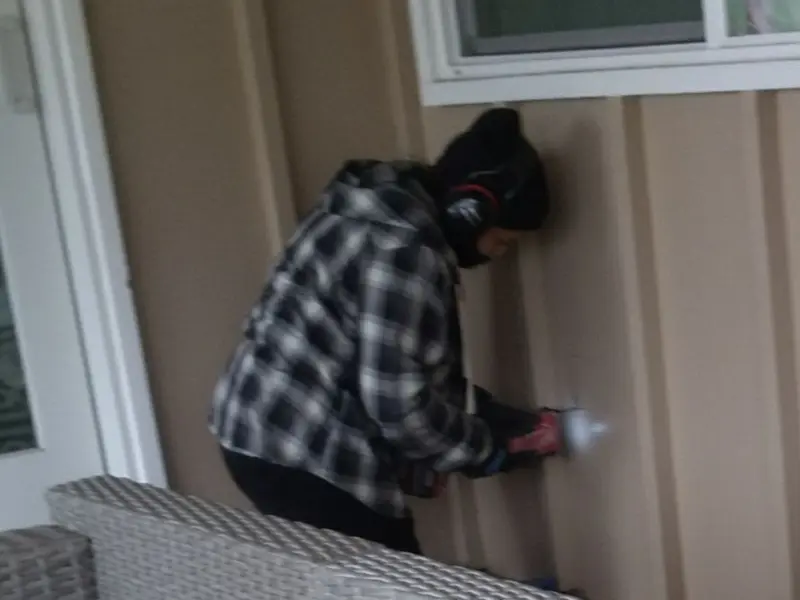 Professional electrician installing an exterior outlet in Napoleon